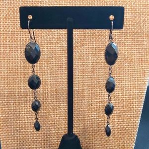 Long black dangling EARRINGS.